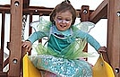 Sliding in her costume is double the fun!