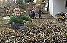 Jimmy jumping in the leaf pile