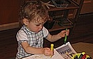 Nicholas loves coloring with crayons