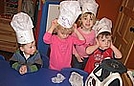 Everyone's wearing chef hats as they are waiting for the dough to mix