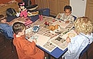 The kids are creating still life paintings of an object of their choice