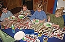 Painting paper plates to create christmas trees