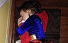 Super girl is taking a nap with her Elmo