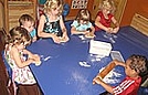 Flattening their personal pizza doughs