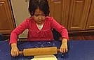 Olivia is rolling out the dough!